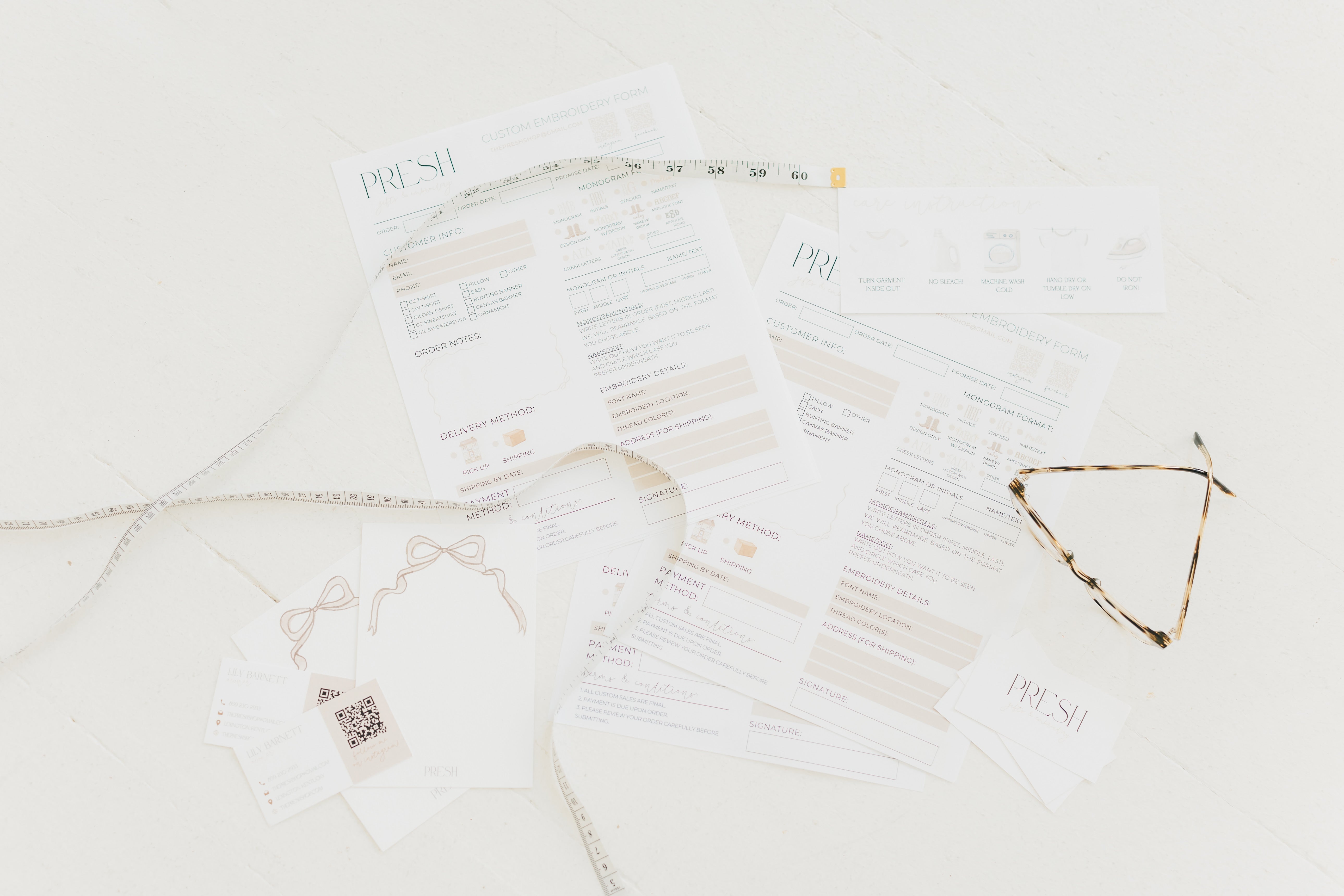 Custom Order Sheets, staged with necklaces and earrings on a white background