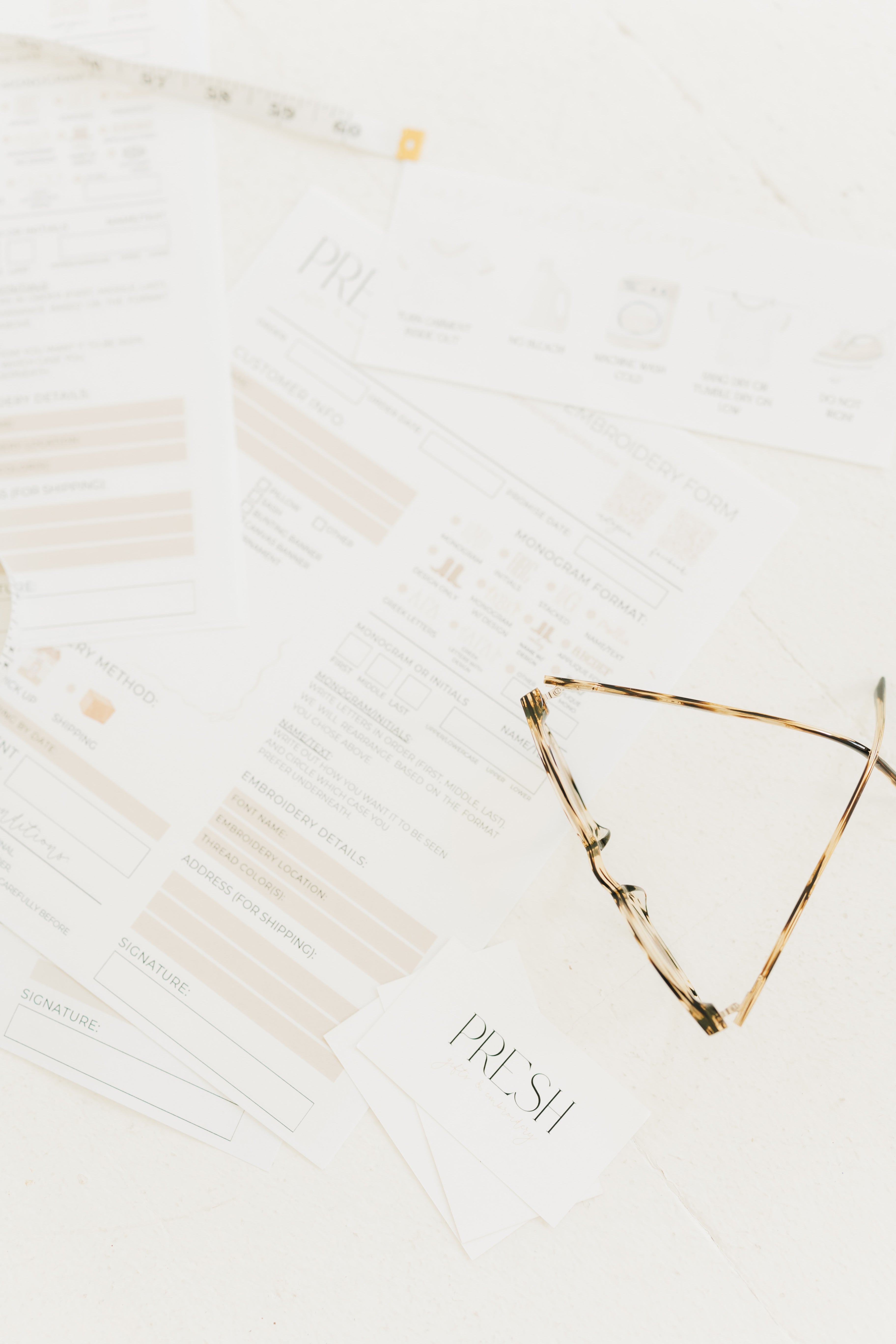 Tortoiseshell eyeglasses on a white surface with 'PREMIUM' branding.